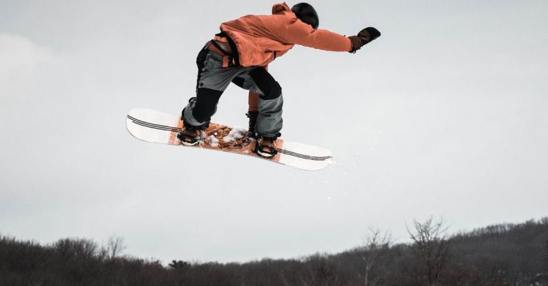 Snowboard - Man in Snowboard Jumping on Ramp