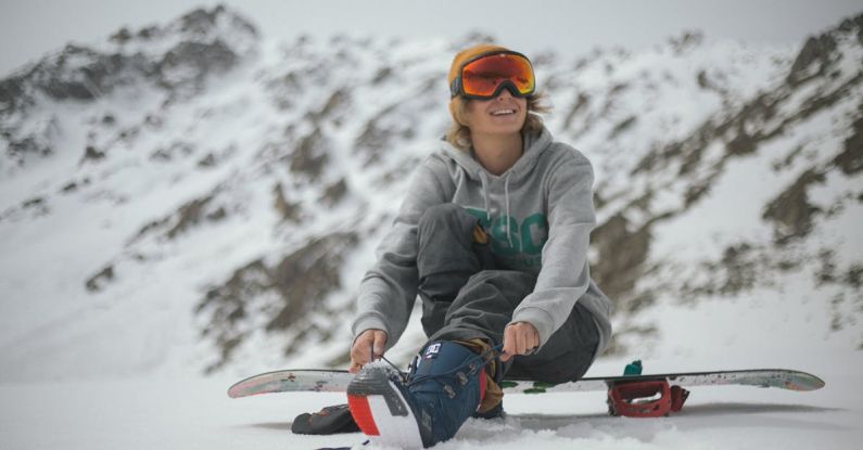 Snowboard - Person in Grey Hoodie Sitting on Snowboard