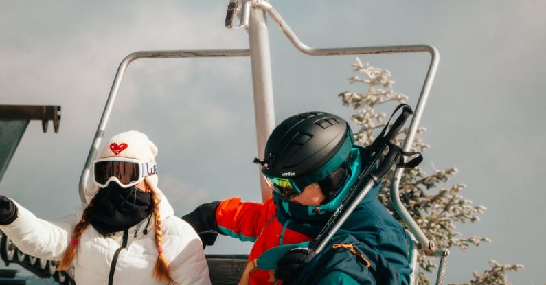 Winter Sport - Two people on a ski lift with skis on